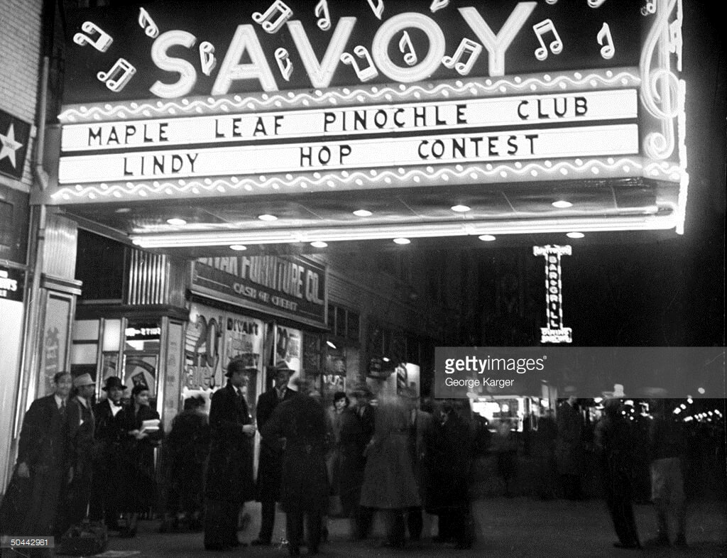 1938 Crowd gathered under Savoy Ballroom marquee announcing a lindy hop contest at night